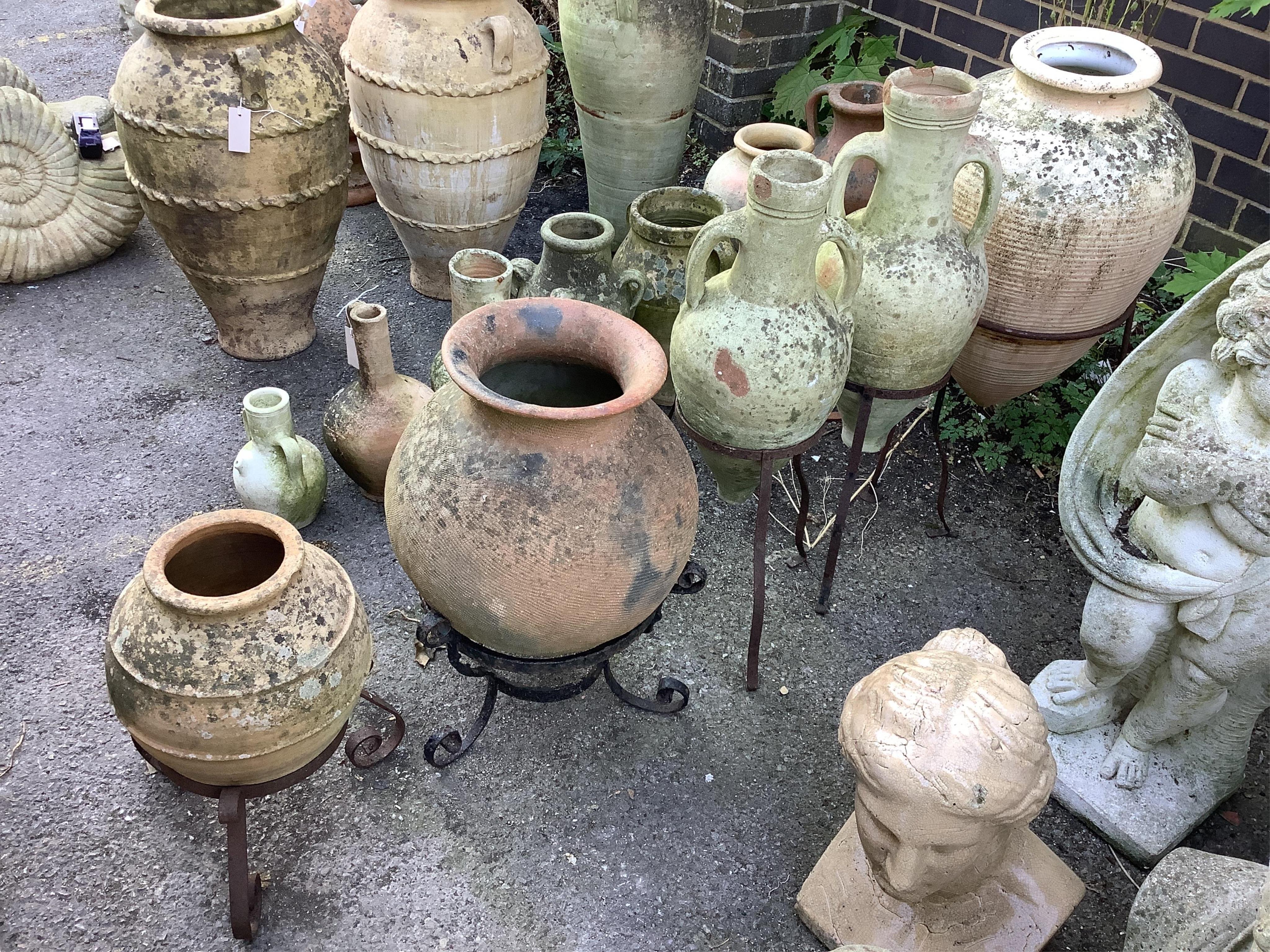 Five earthenware amphora on wrought iron stands, largest height 80cm. Condition - poor to fair